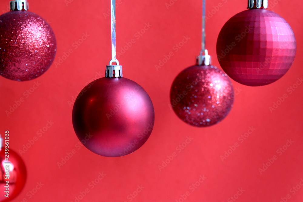 red christmas balls hanging on a red background red christmas balls hanging on a red background