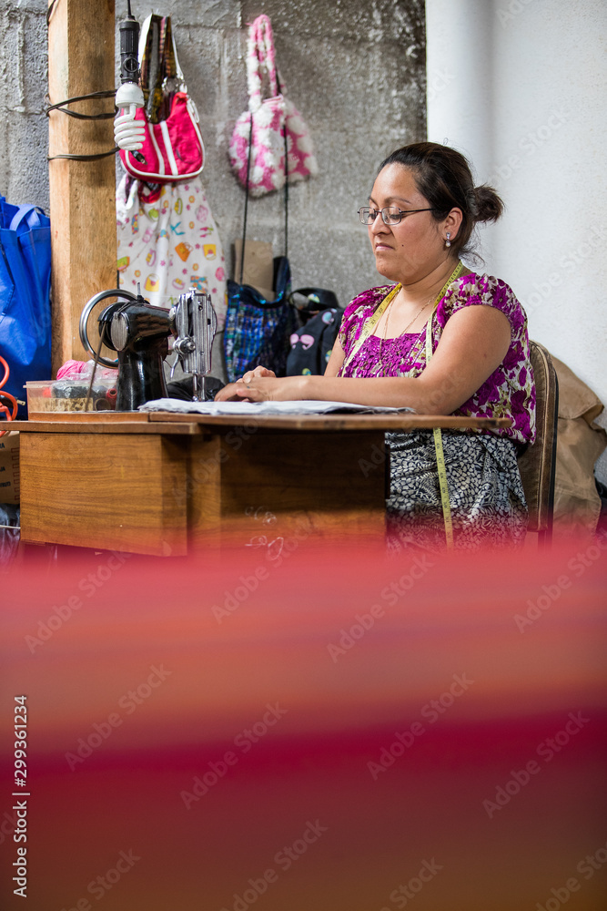 Guatemalan woman working with textiles in in San Juan La Laguna, Lake Atitlan, Guatemala