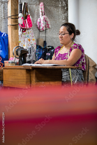 Obraz na płótnie Guatemalan woman working with textiles in in San Juan La Laguna, Lake Atitlan, Guatemala w salonie