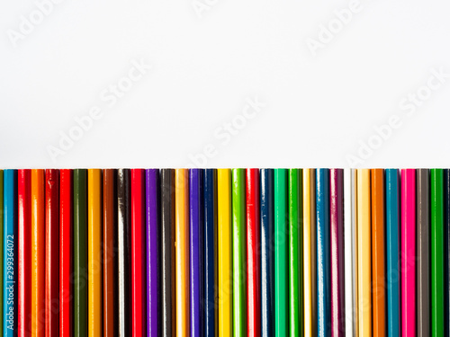Colored pencils on white wooden background, Stationery Concept. Top view with copy space.