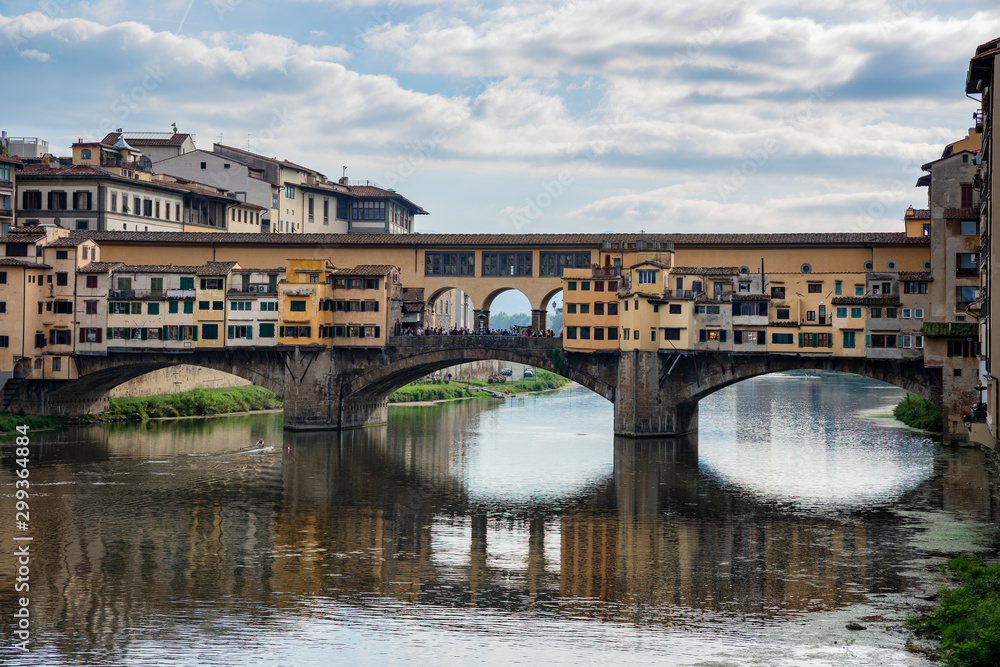 FLORENCE, TUSCANY/ITALY - OCTOBER 20 : Ponte Vecchio across the River Arno in Florence  on October 20, 2019. Unidentified people.