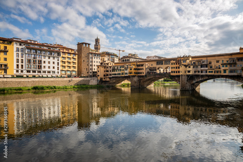 FLORENCE, TUSCANY/ITALY - OCTOBER 20 : Ponte Vecchio across the River Arno in Florence on October 20, 2019. Unidentified people.