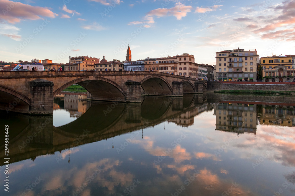 FLORENCE, TUSCANY/ITALY - OCTOBER 19 : View of buildings along the River Arno at dusk  in Florence  on October 19, 2019. Unidentified people