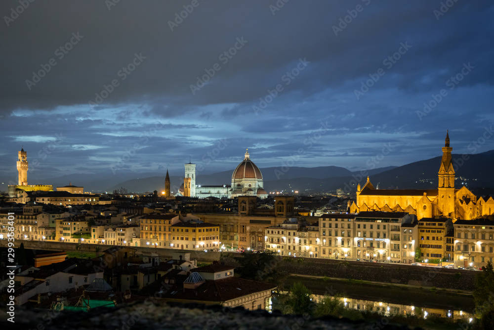FLORENCE, TUSCANY/ITALY - OCTOBER 18 : Distant view of Florence Cathedral and Santa Croce Basilica at dusk in Florence on October 18, 2019