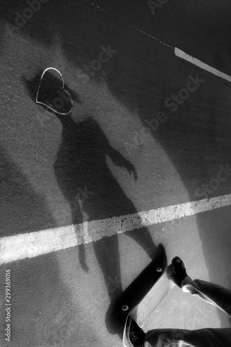 skateboard shadow on the sidewalk photo