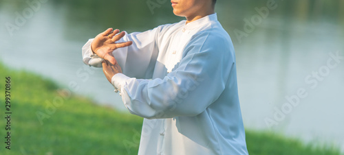 Asian healthy man with Tai Chi pose.