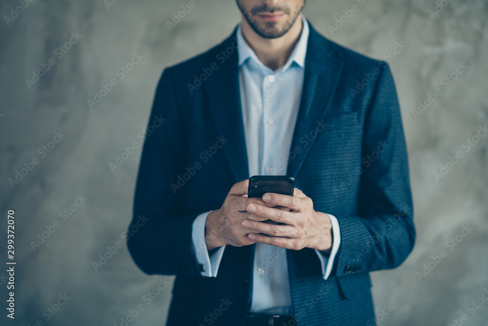 Cropped photo of focused agent using his smartphone have online chatting with his clients colleagues wear modern outfit isolated over grey color background Cropped photo of focused agent using his smartphone have online chatting with his clients colleagues wear modern outfit isolated over grey color background
