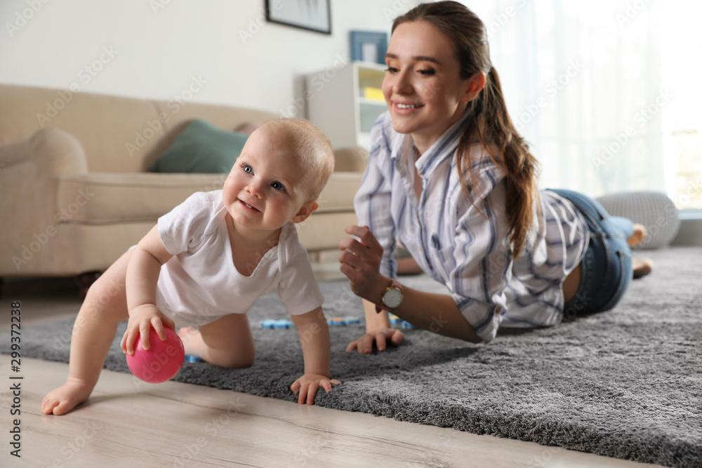 Adorable little baby crawling near mother at home Adorable little baby crawling near mother at home