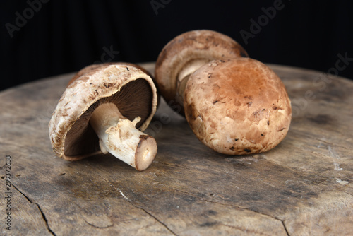 Fresh champignon mushrooms on wooden table, closeup. Space for text