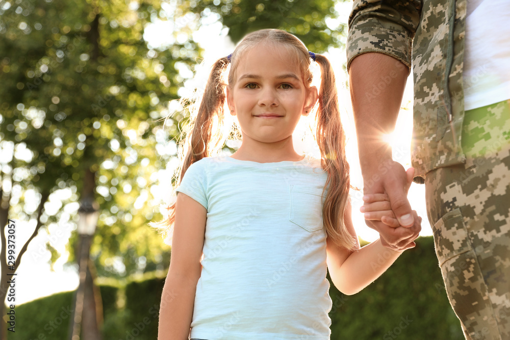 Father in military uniform walking with his daughter at sunny park Father in military uniform walking with his daughter at sunny park