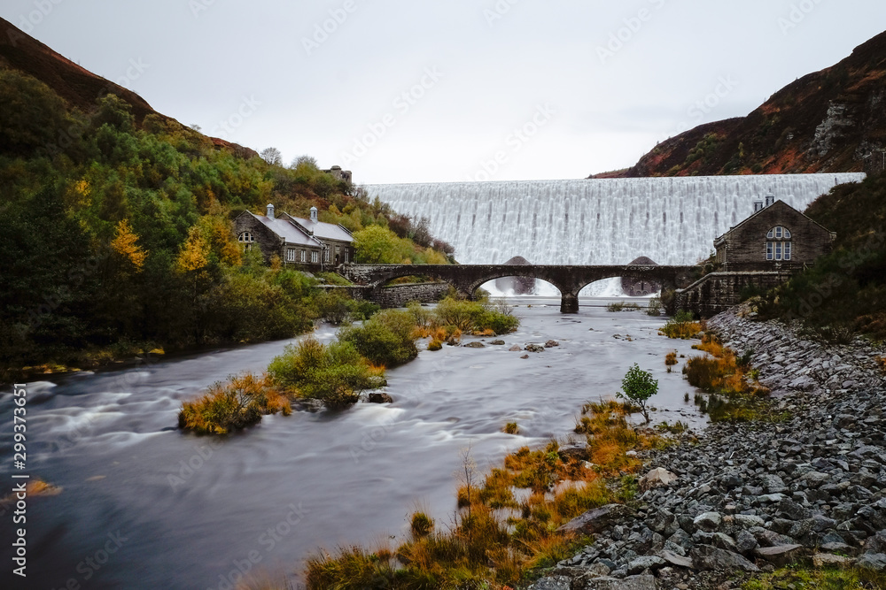 Autumn scene of water flowing over the Caban Coch Dam in Elan Valley Autumn scene of water flowing over the Caban Coch Dam in Elan Valley