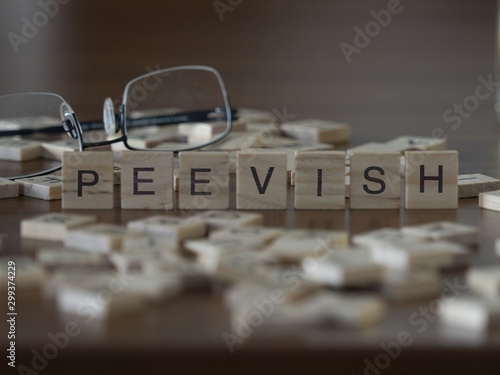 The concept of Peevish represented by wooden letter tiles