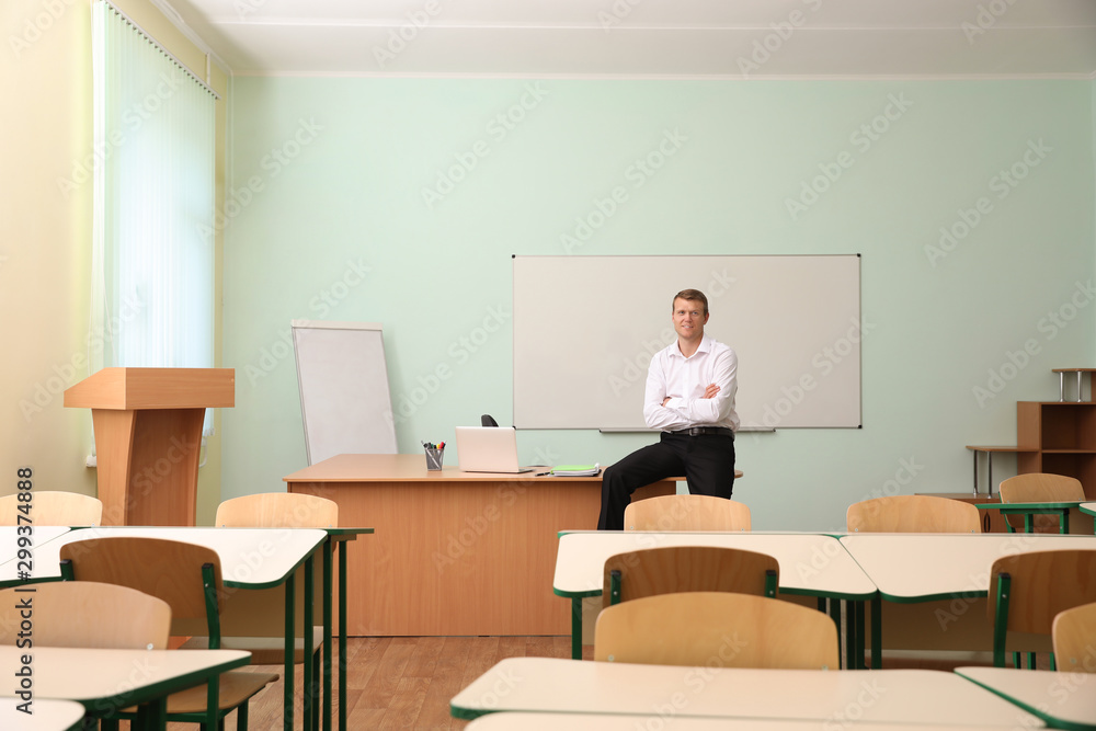 Portrait of male teacher in modern classroom Portrait of male teacher in modern classroom