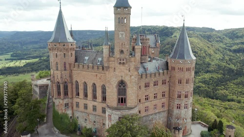 Aerial panorama of Burg Hohenzollern (Hohenzollern castle) with hills and villages surrounded by forests with beautiful foliage