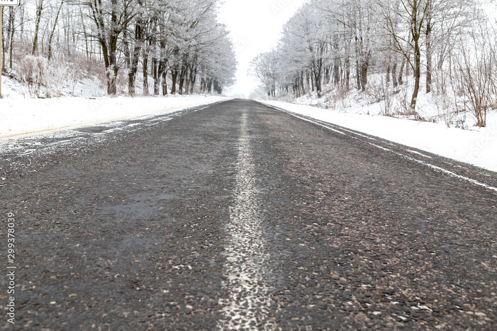 Rural winter season asphalt road with trees covered up in hoar frost. Rural winter season asphalt road with trees covered up in hoar frost.