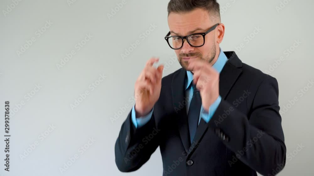 Portrait of a formally dressed bearded man with glasses looking at the camera Portrait of a formally dressed bearded man with glasses looking at the camera