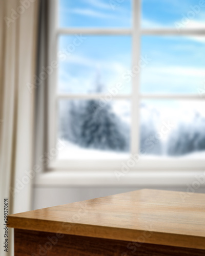 Wooden corner table of free space for your decoration and blurred window. 