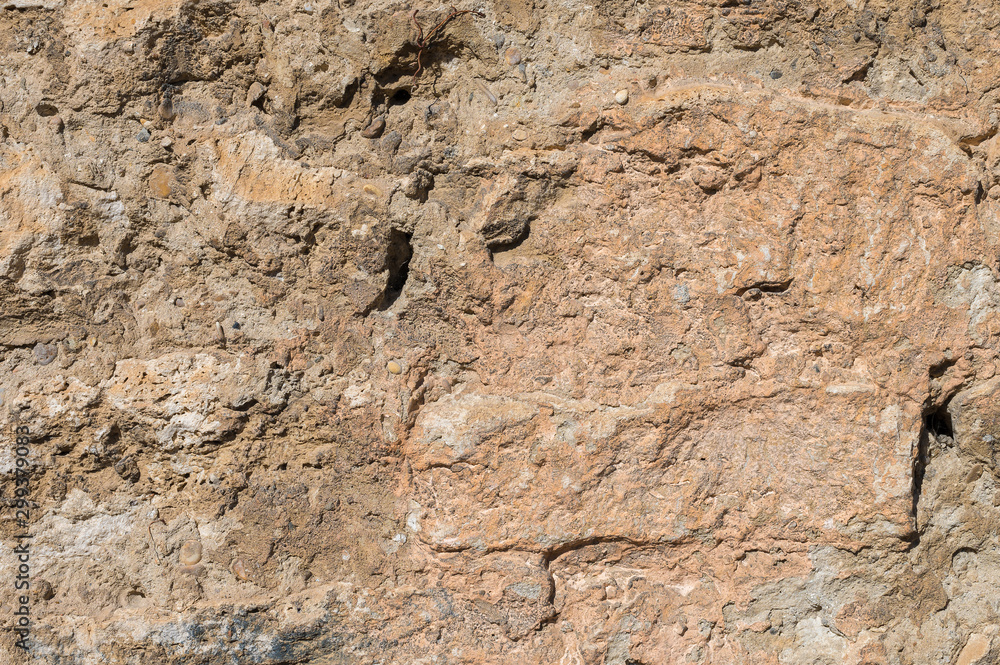 Ancient stone building mix of the exposed facade of the building during restoration. Grunge Abstract Background