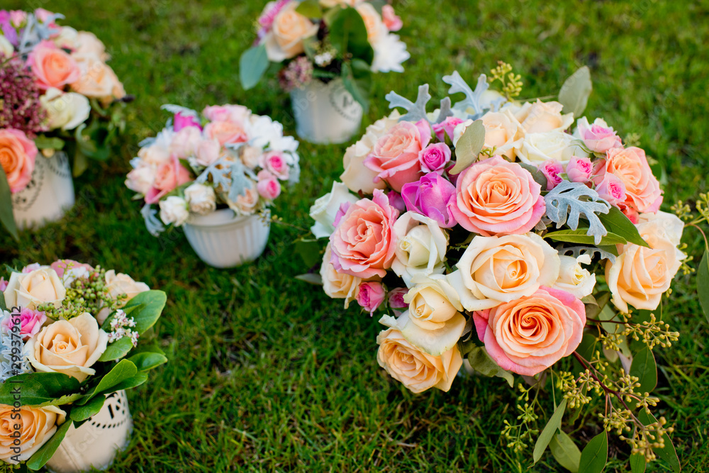 Five different wedding bouquets on a green grass. Close-up.