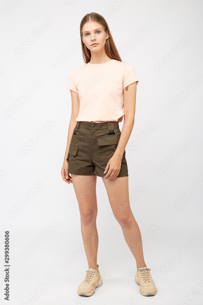 Teenager girl in khaki cargo shorts Teenager girl in khaki cargo shorts