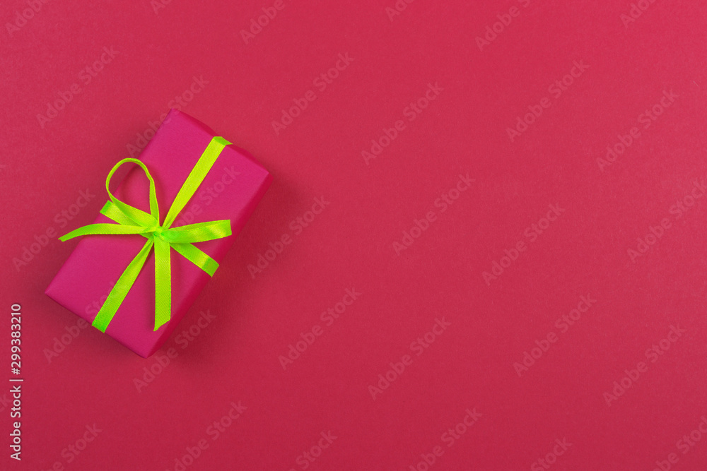 Gift box with ribbon and bow on color background and space for text. Top view - Image Gift box with ribbon and bow on color background and space for text. Top view - Image