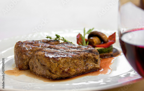 grilled vegetables steak with sauce on a white plate. restaurant serving, tasty and healthy food