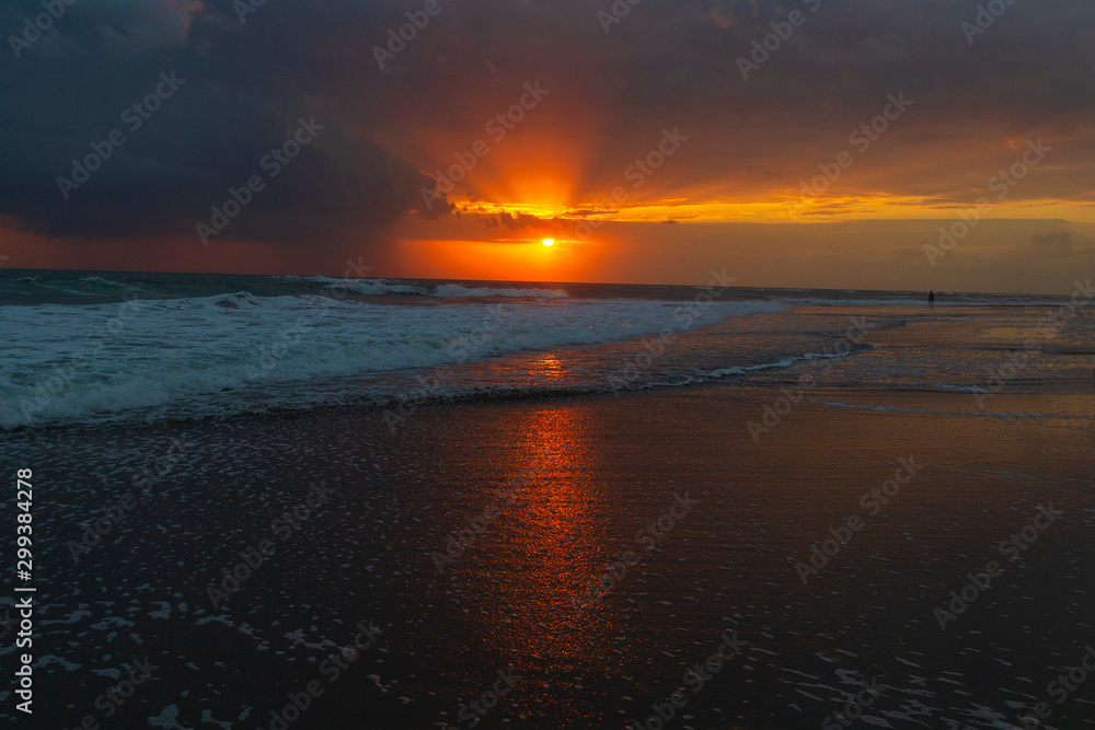Fototapeta premium Beautiful colorful sunset at the sea with dramatic clouds and sun shining.Colorful dawn over the sea. Nature composition.