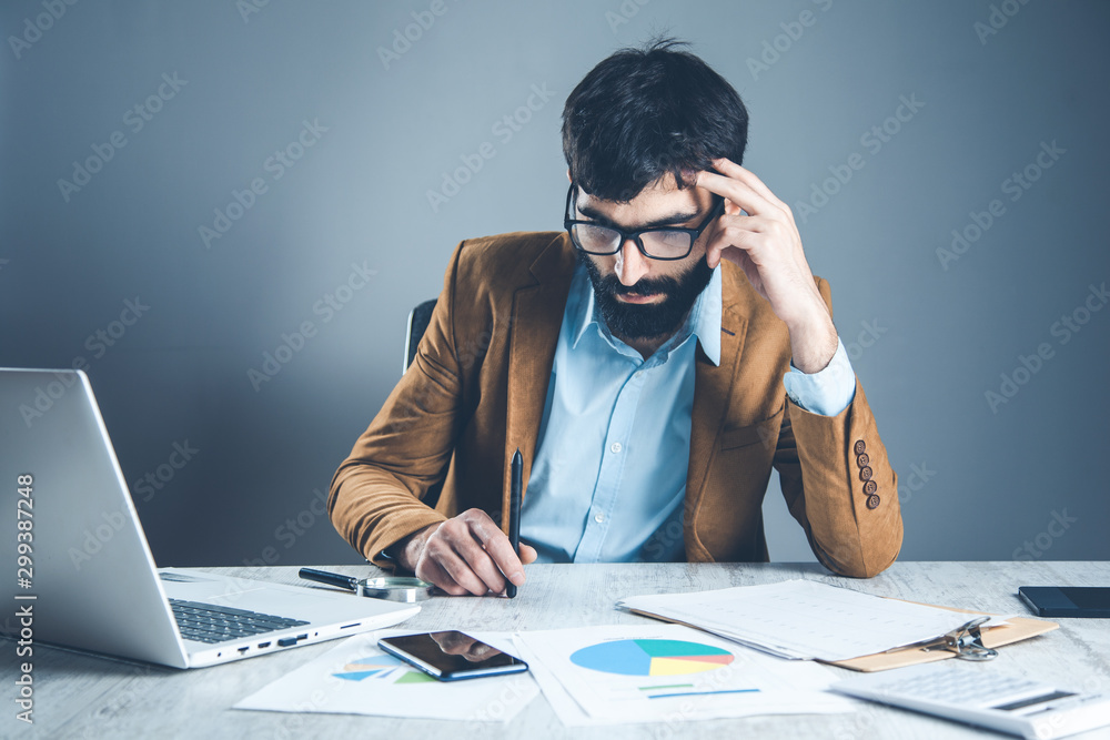 business man in office desk on gray wall background business man in office desk on gray wall background
