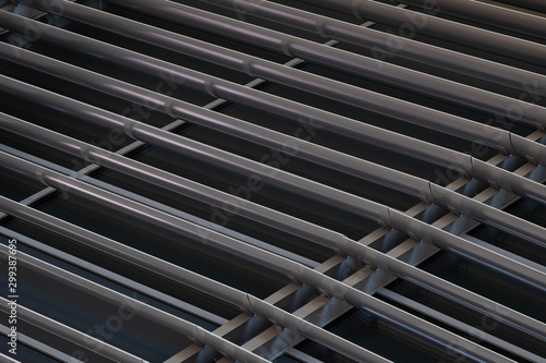 Angular view close-up of dark metal beams structure in fragment of building