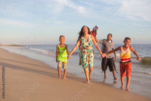 happy family at the beach flying a kite