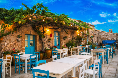 Fototapeta Naklejka Na Ścianę i Meble -  Famous colorful outdoor cafe in the most beautiful sicilian village Marzamemi in Sicily, south Italy