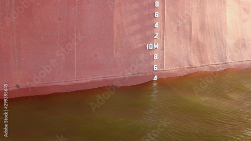 Waterline. A bulbous bow of a cargo ship in the ocean. The bulb modifies the way the water flows around the hull, reducing drag and thus increasing speed, range, fuel efficiency, and stability.