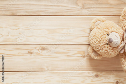 teddy on wooden background