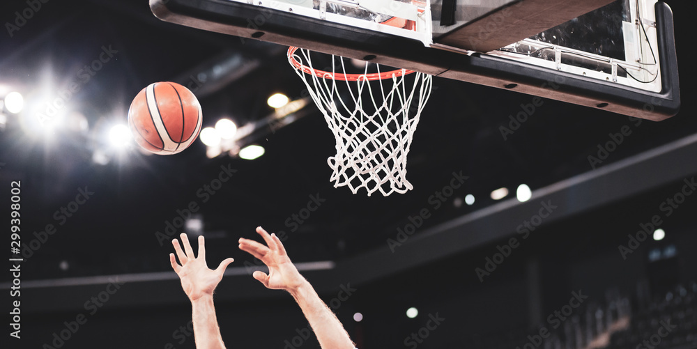 scoring during a basketball game ball in hoop