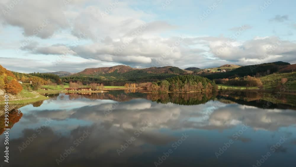 Unreal Scandiavian Landscape Aerial Scene. Sky Mirror Reflection on Calm Lake Water and Autumn Foliage on Coast Unreal Scandiavian Landscape Aerial Scene. Sky Mirror Reflection on Calm Lake Water and Autumn Foliage on Coast