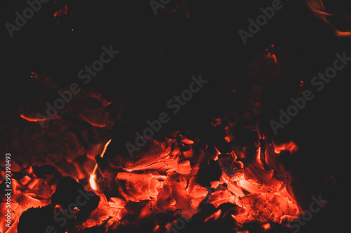 Orange red bright colorful embers dying bonfire.