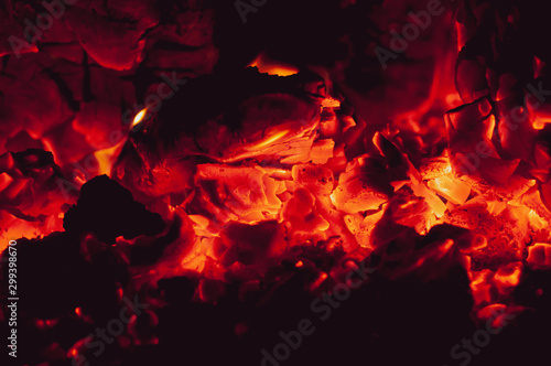 Orange-red bright colorful embers dying bonfire.