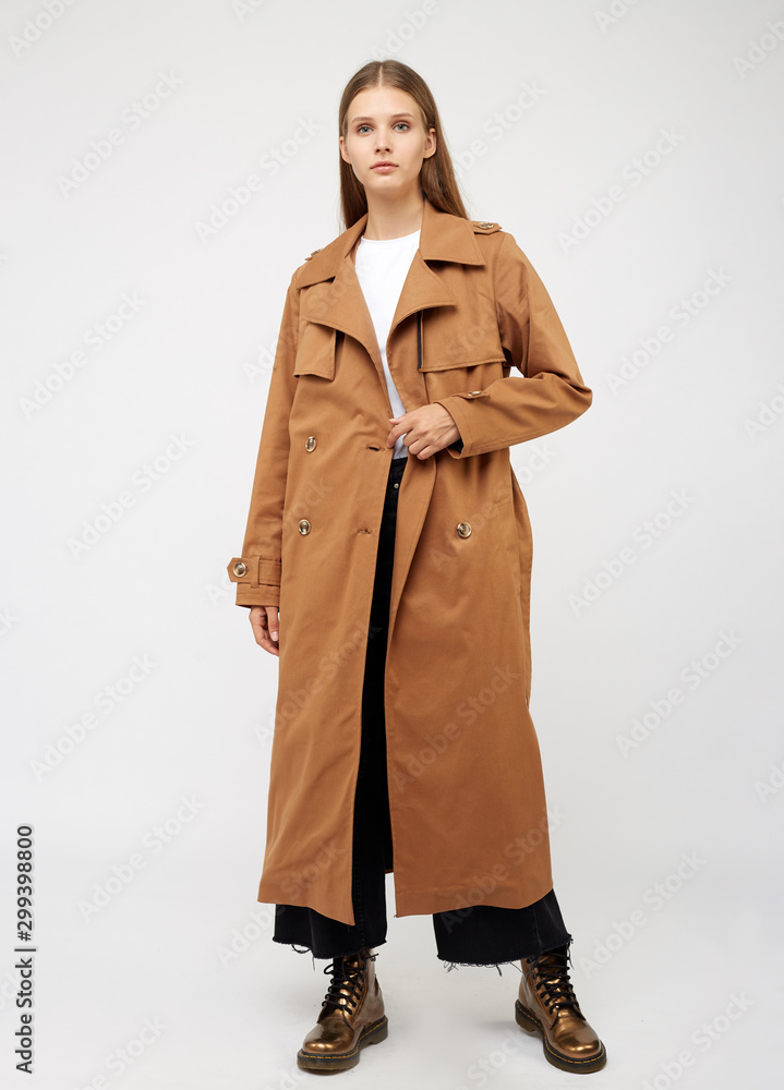 Female trench coat camel color isolated on white background. Female trench coat camel color isolated on white background.