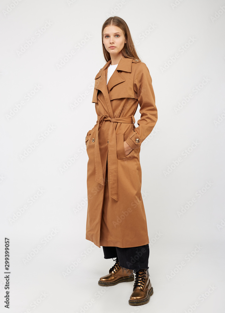 Female trench coat camel color isolated on white background. Female trench coat camel color isolated on white background.