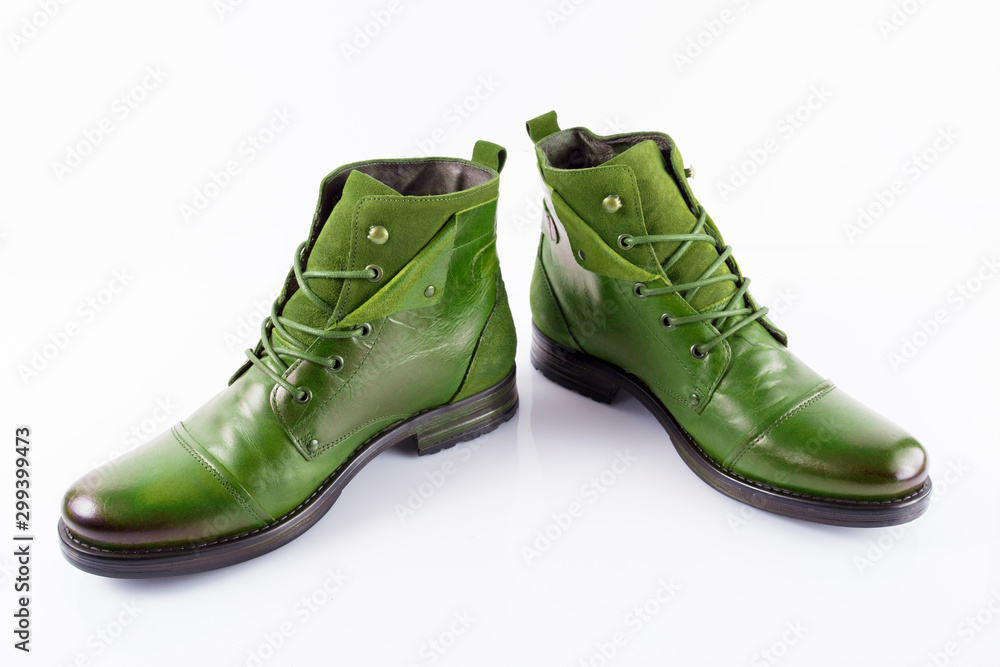 Pair of male green leather boots on white background, isolated product, top view.