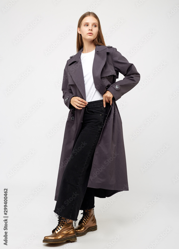 Female trench coat. Charcoal color. Isolated on white background. Female trench coat. Charcoal color. Isolated on white background.