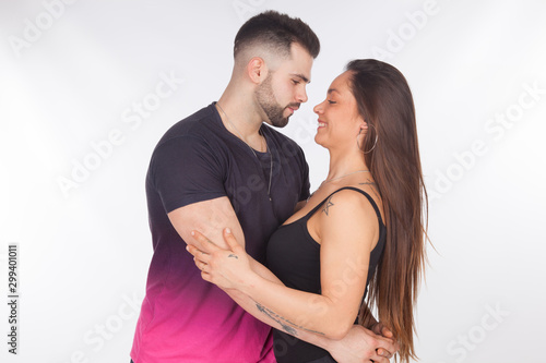 Fotografía Pareja de enamorados, abrazándose y dandose cariños sobre un fondo blanco; pareja heterosexual, felices y contentos