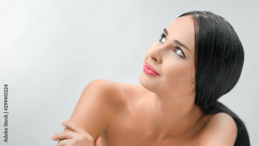 Charming happy female enjoying gentle softness skin stroking naked shoulder posing isolated Charming happy female enjoying gentle softness skin stroking naked shoulder posing isolated