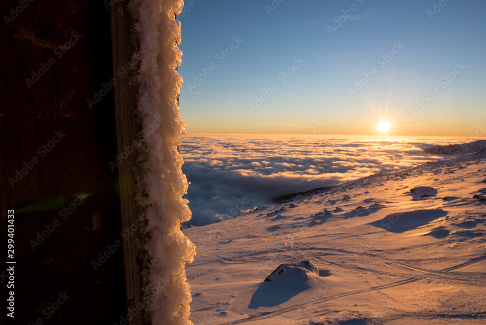 Ice Coated Foreground And Beautiful Cloud Inversion Sunset In The Background
