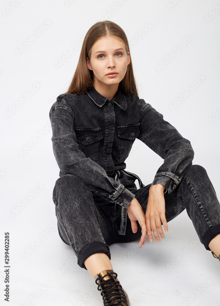 Girl in black denim jumpsuit on white background. Girl in black denim jumpsuit on white background.