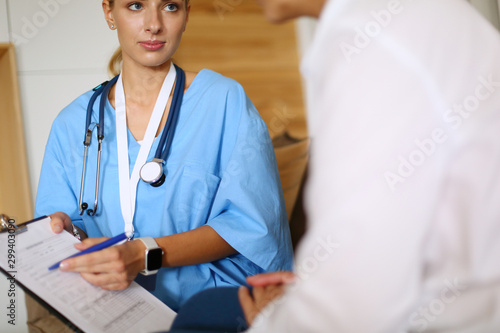 Woman doctor explaining diagnosis to her female patient