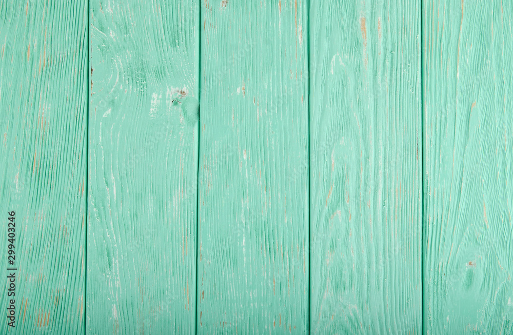 Obraz premium Light turquoise painted wooden background with parallel vertical planks 