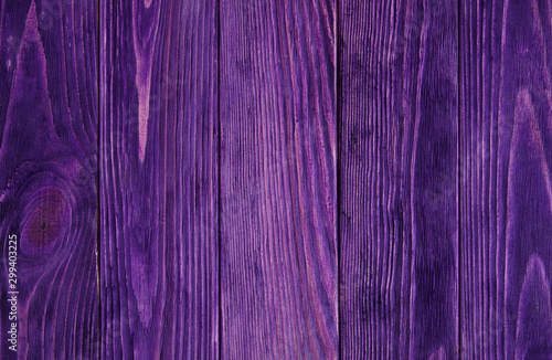 Purple violet saturated painted wooden background with parallel vertical planks 