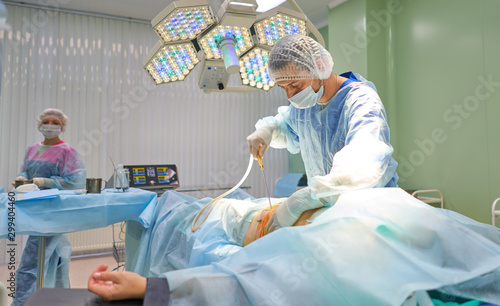 surgeon during liposuction