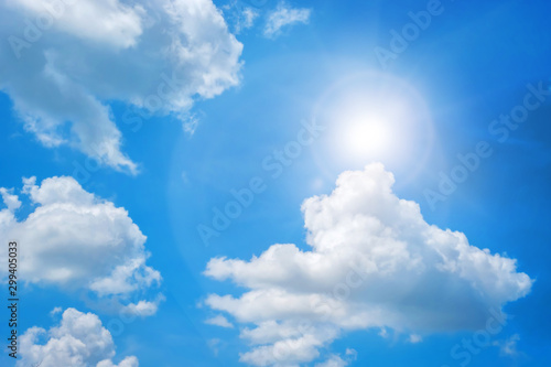 Background of clouds and sunlight against deep blue sky